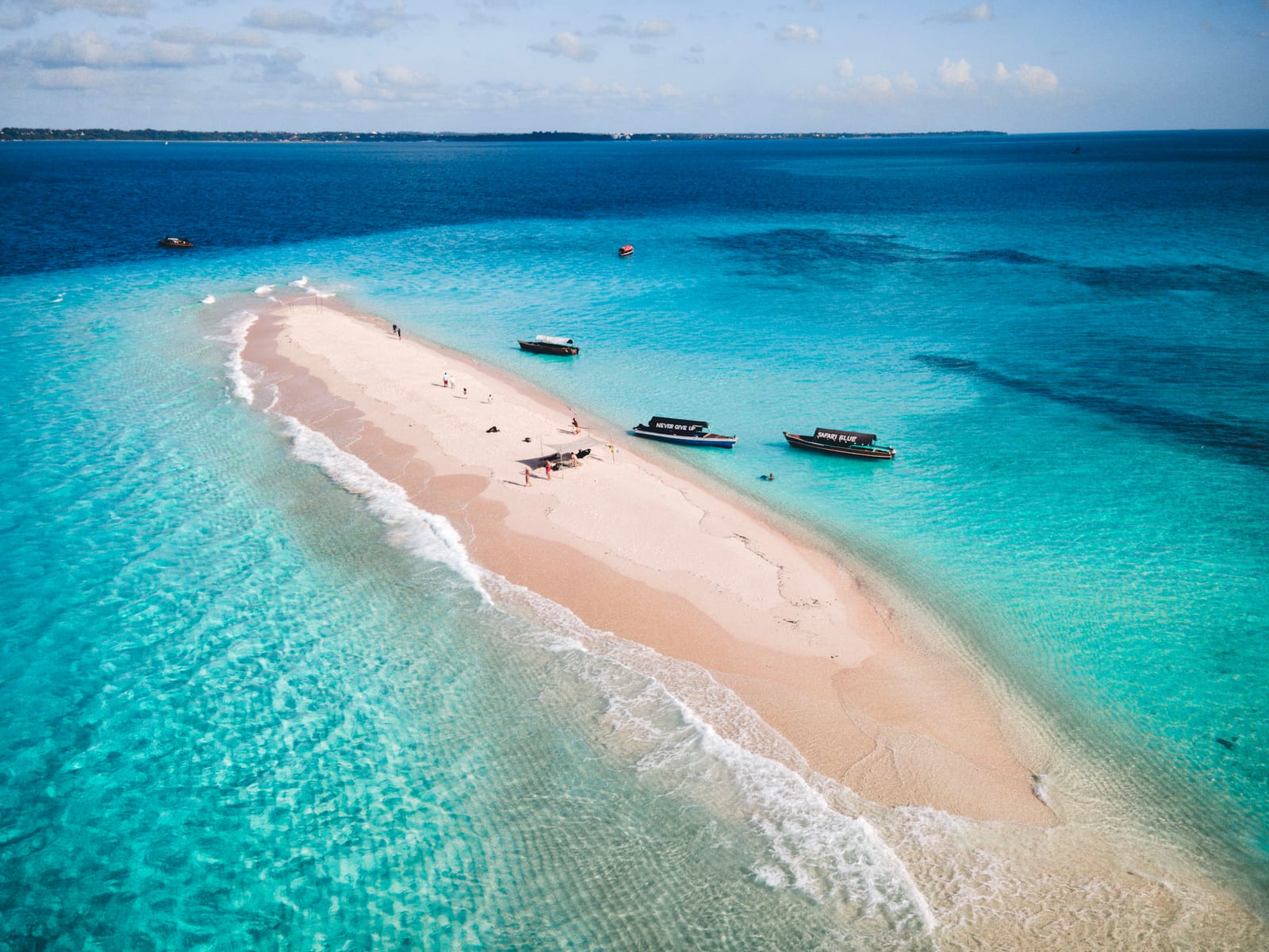 Aerial view of a white sandbank surrounded by turquoise water on a Safari Blue excursion