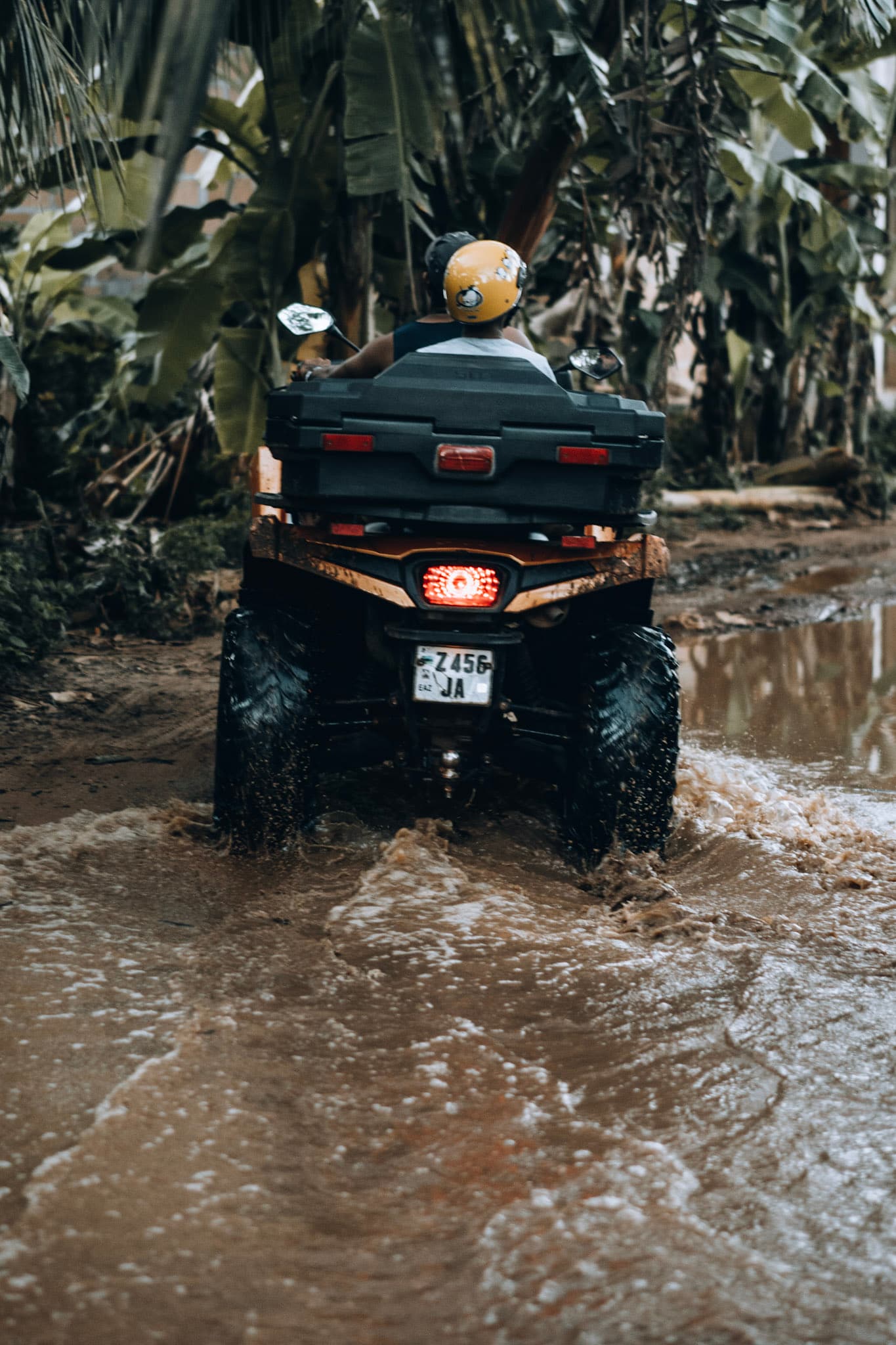 ATV rider powering through a muddy jungle trail on Zanzibar